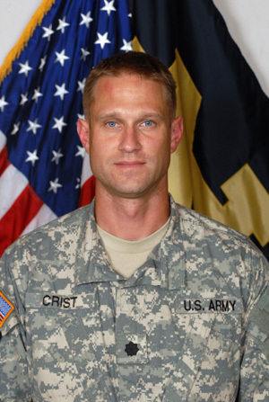 Headshot of LTC Crist with American flag and Notre Dame flag in background