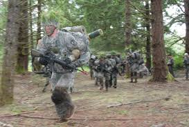 Cadets with full ruck march through woods during the advanced training camp